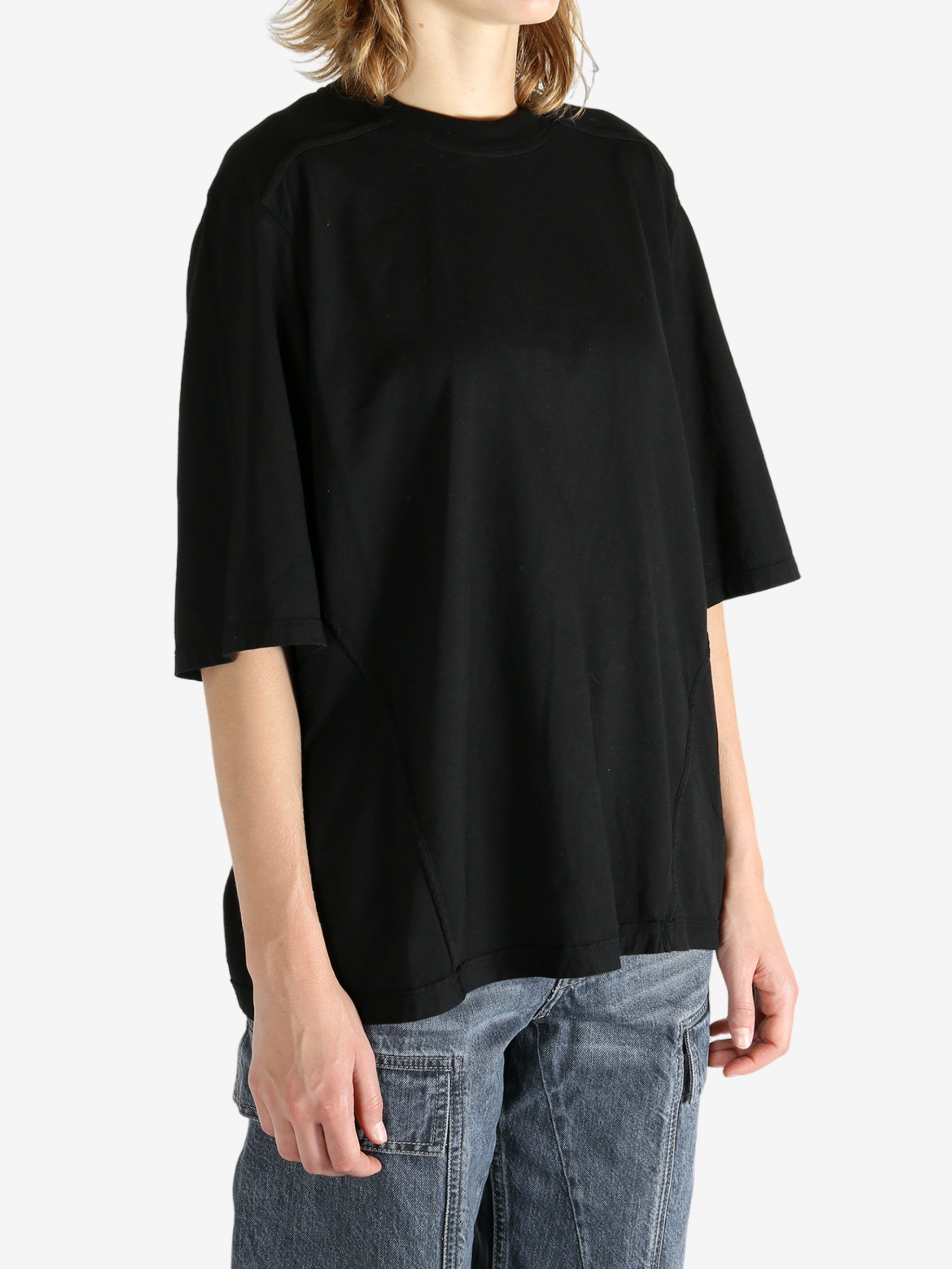 Black t-shirt worn by a person, showing the shirt's fit