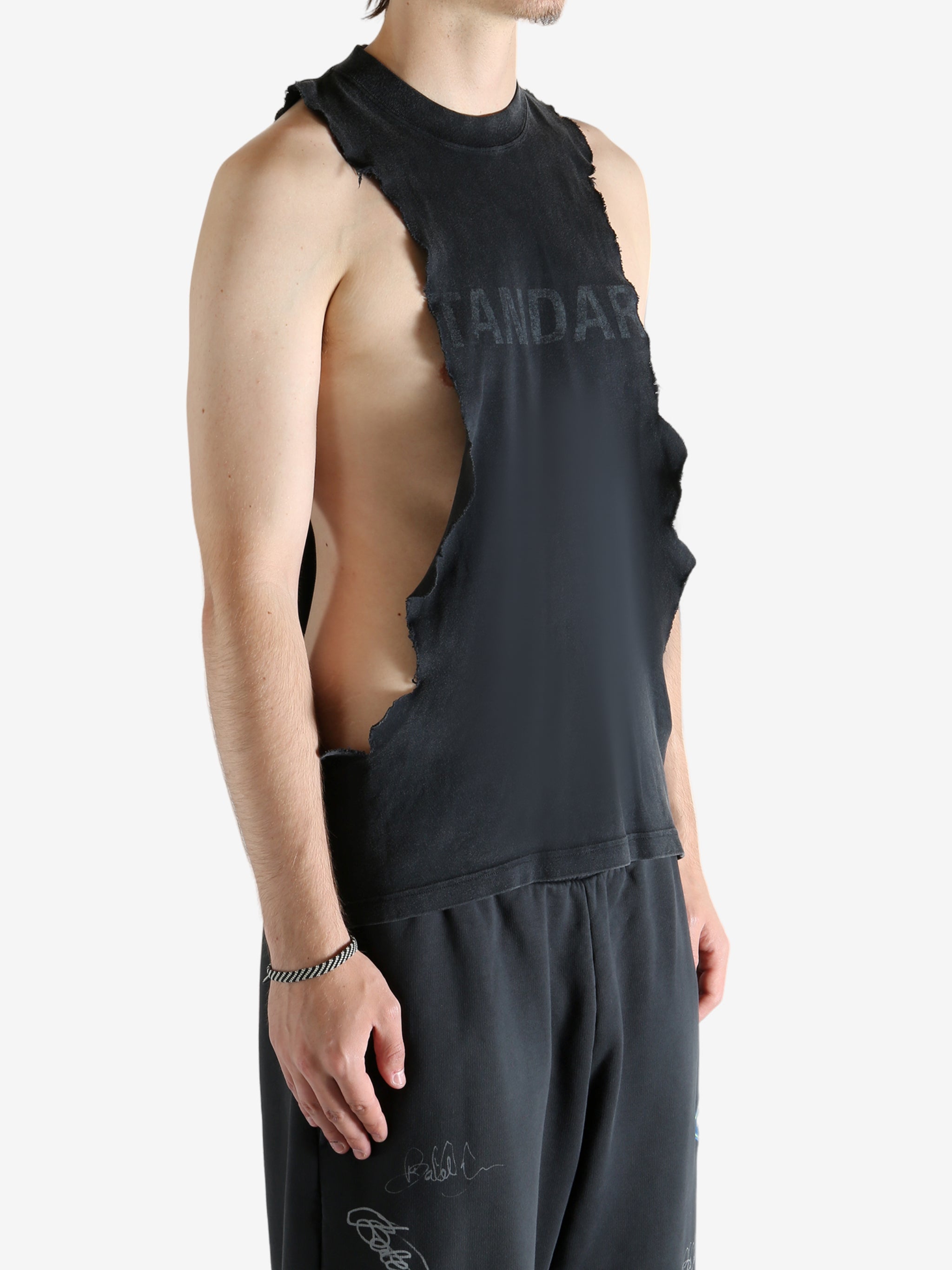 Black tops worn by a person, showing the tops's fit