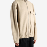 Tan shirt worn by a person, showing the shirt fit
