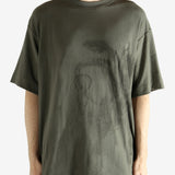 Green t-shirt worn by a person, showing the t-shirt's fit