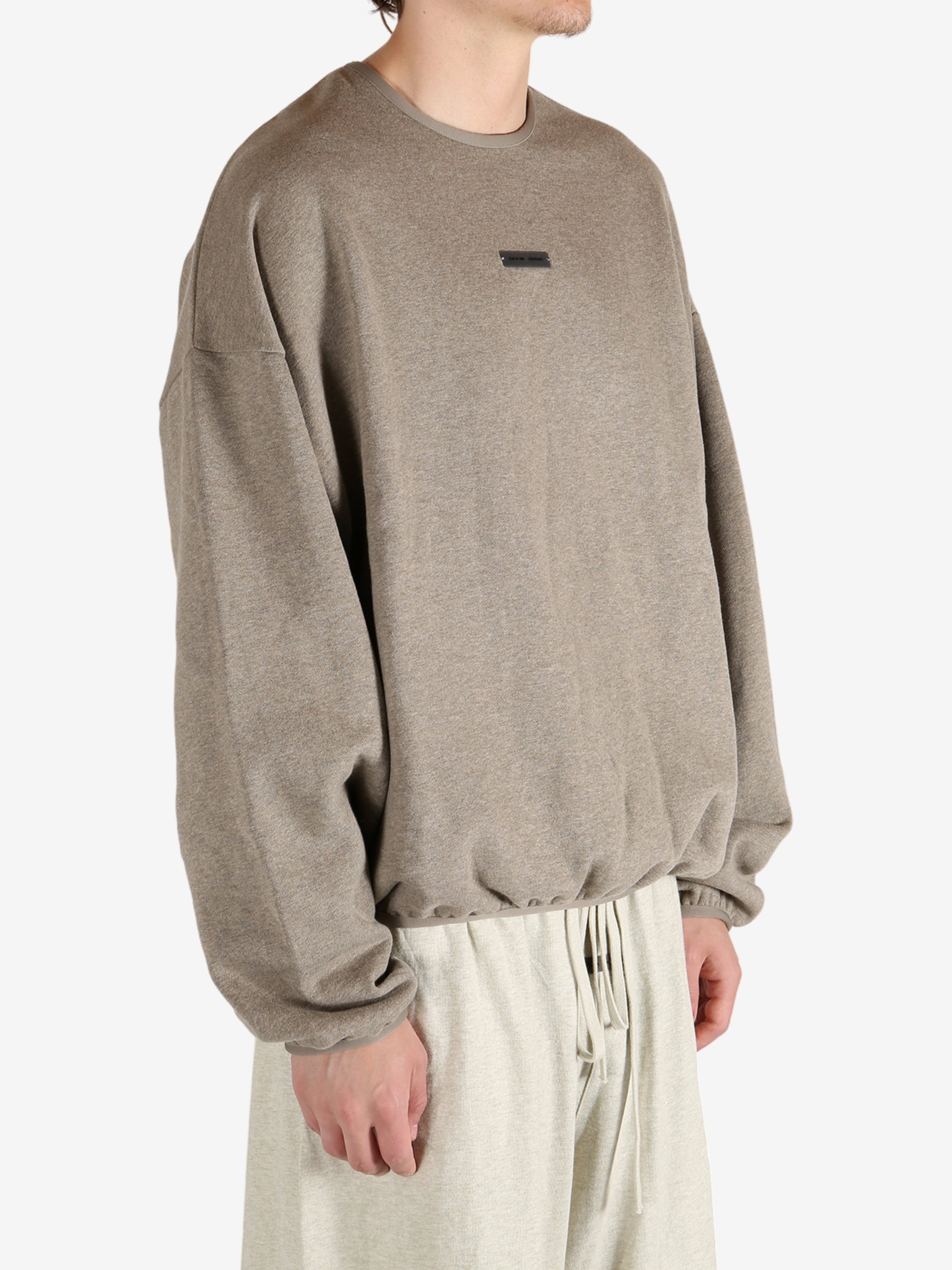 Tan tops worn by a person, showing the tops fit