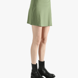 Green skirt worn by a person, showing the loose fit.