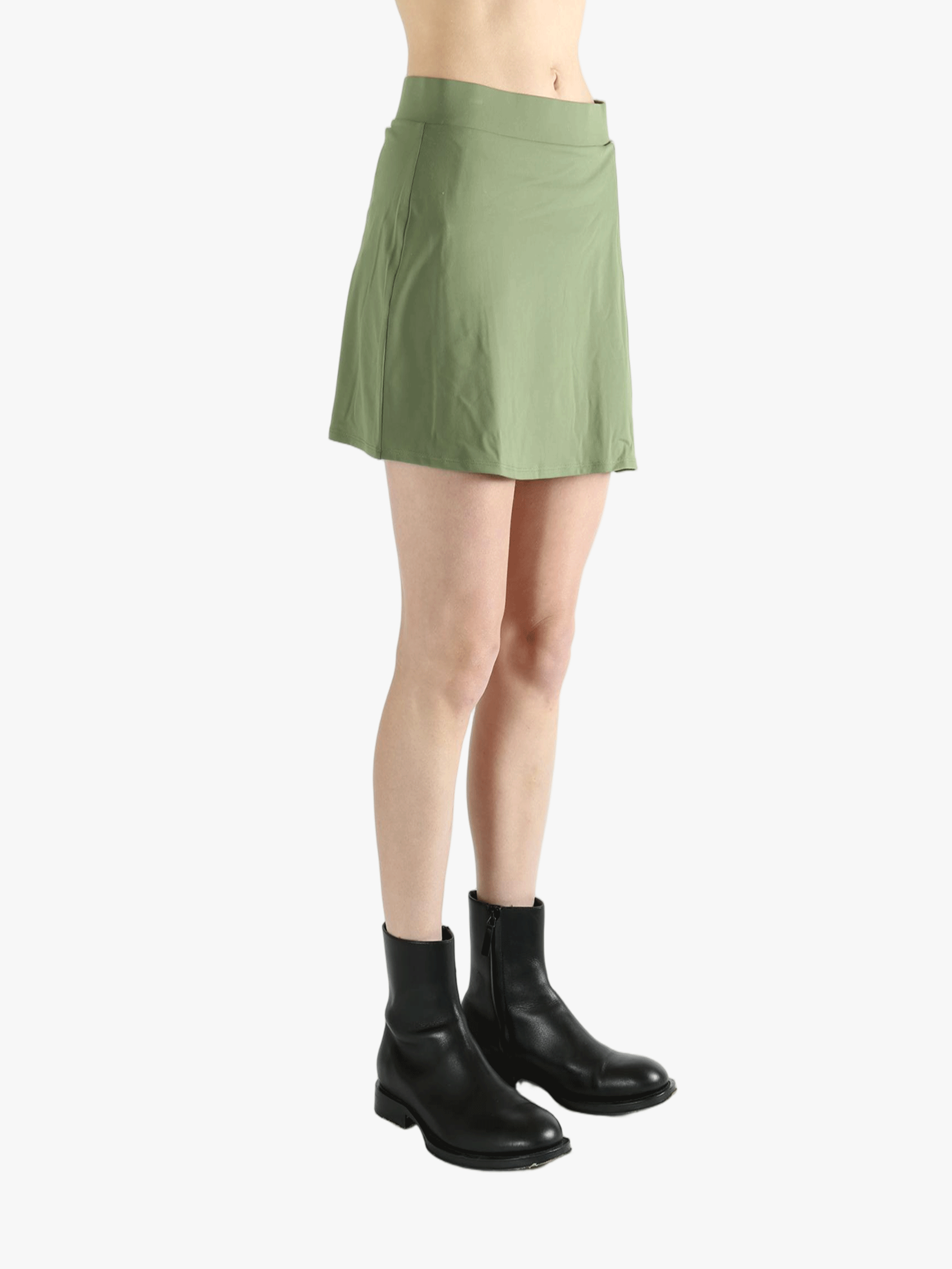 Green skirt worn by a person, showing the loose fit.