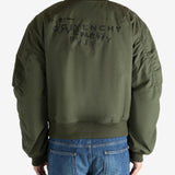 Green jacket worn by a person, showing the jacket fit