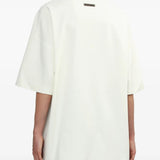 White Tee worn by a person, showing the T-shirt's ft