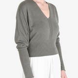Grey top worn by a person, showing the top fit