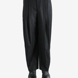 Black pants worn by a person, showing the pants fit