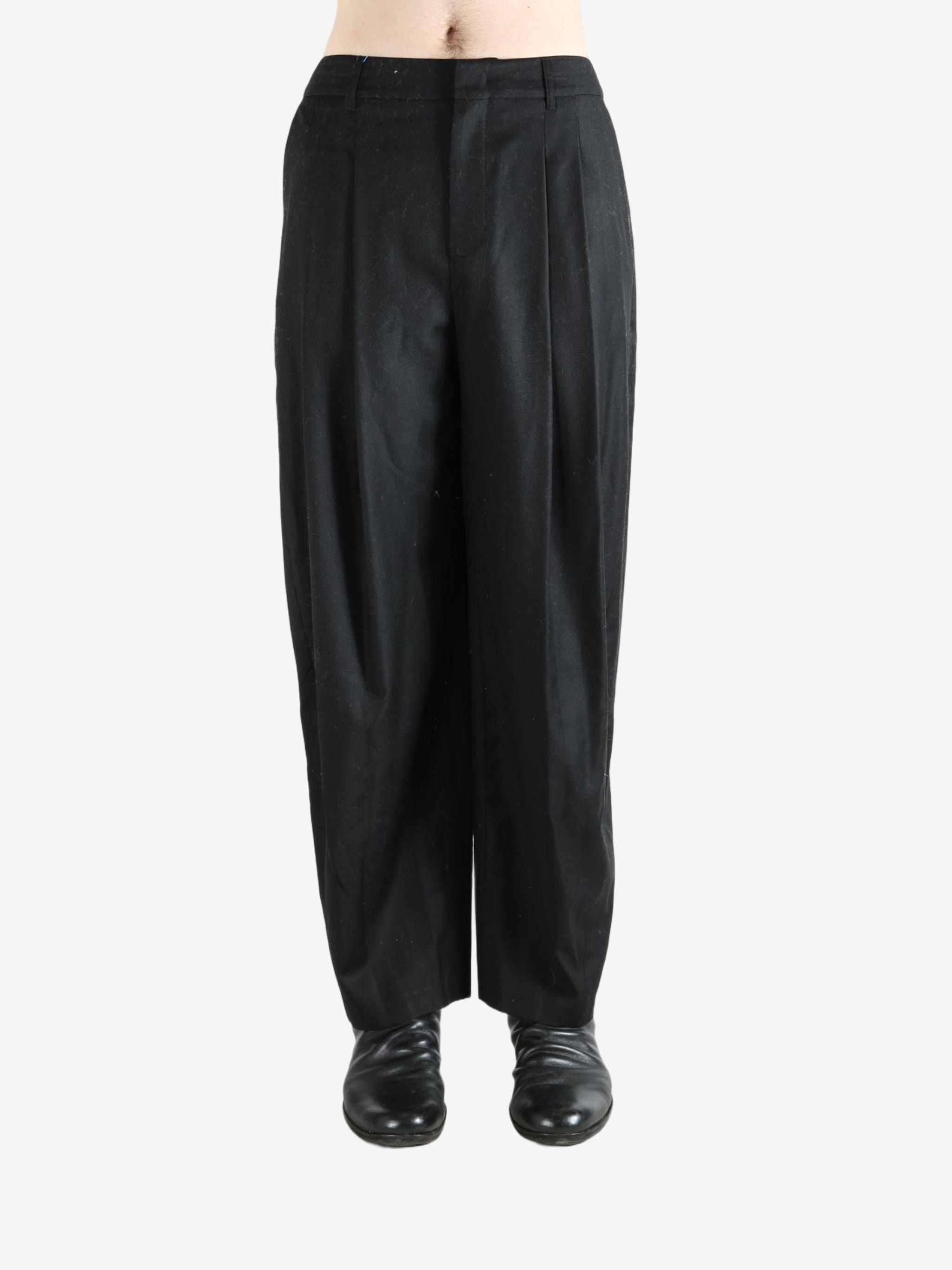 Black pants worn by a person, showing the pants fit