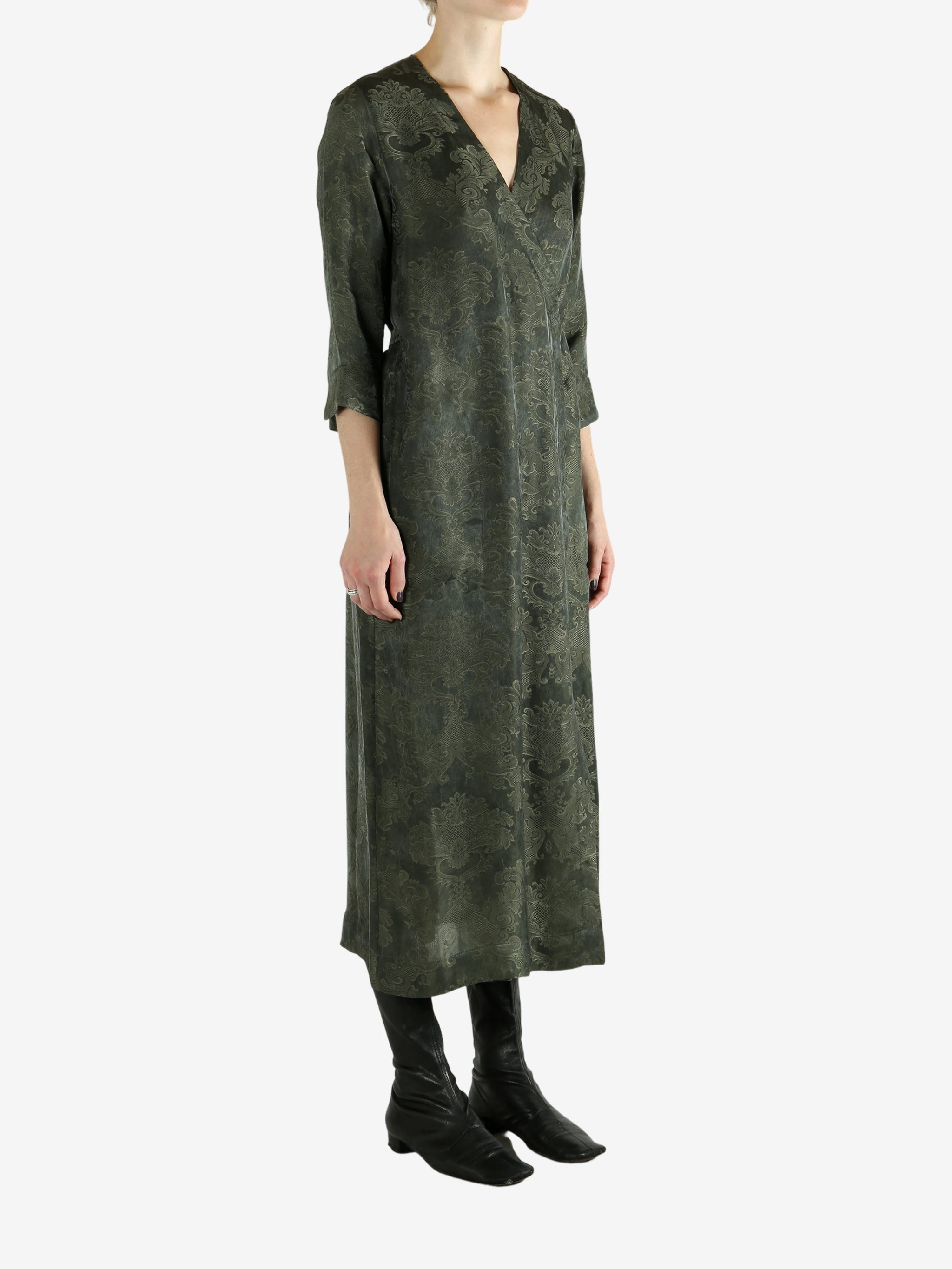 Green dress worn by a person, showing the dress's fit