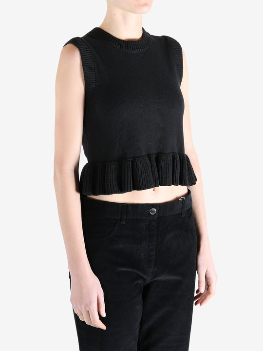 Black top worn by a person, showing the top's fit