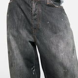 Black jeans worn by a person, showing the jeans fit