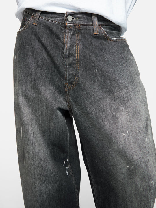 Black jeans worn by a person, showing the jeans fit