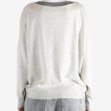 White knitwear worn by a person, showing the knitwear fit