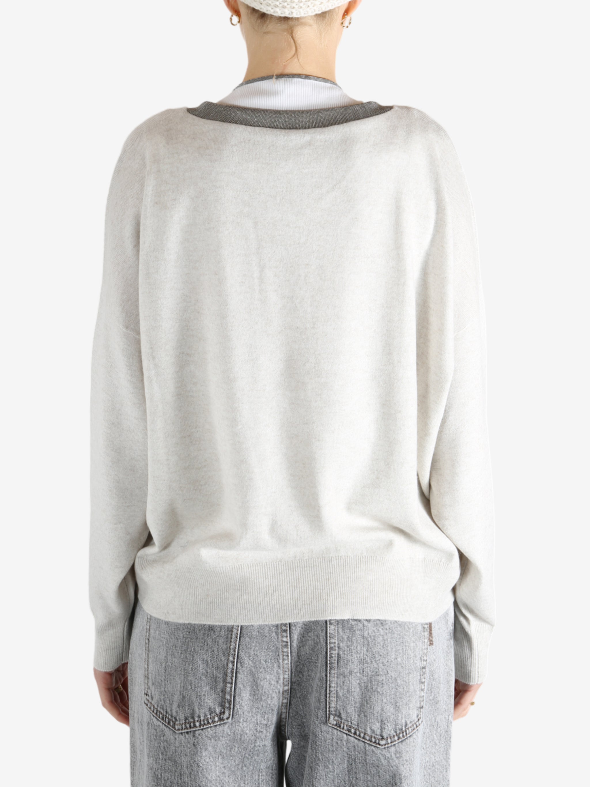 White knitwear worn by a person, showing the knitwear fit