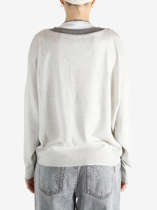 White knitwear worn by a person, showing the knitwear fit