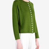 Green knitwear worn by a person, showing the knitwear fit