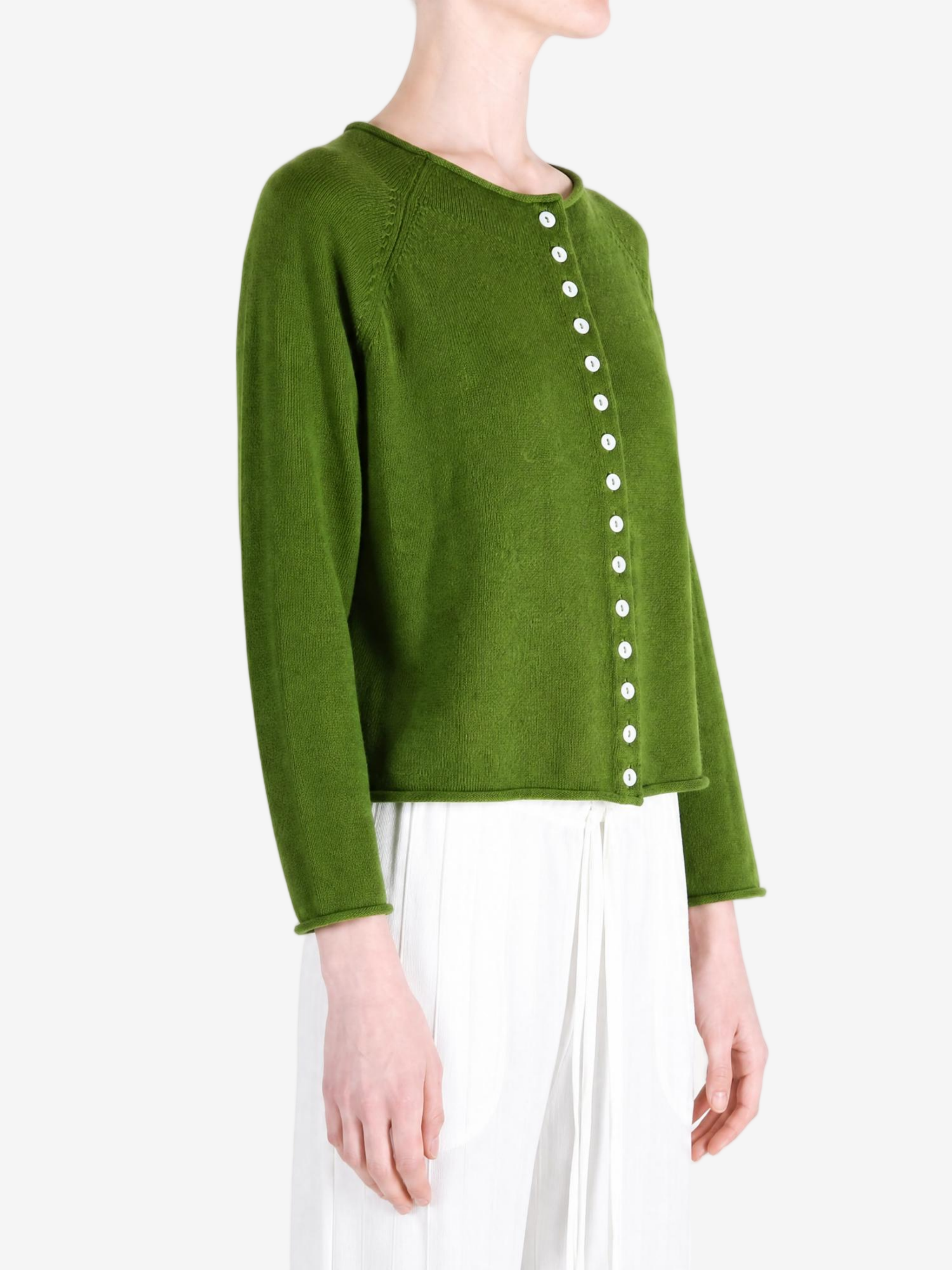 Green knitwear worn by a person, showing the knitwear fit