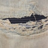 Close up of the blue jeans, showing texture of the cotton fabric