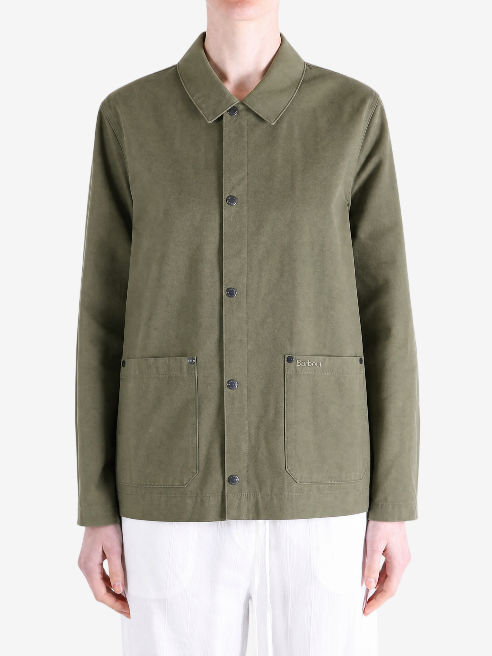 Green jacket worn by a person, showing the jacket fit
