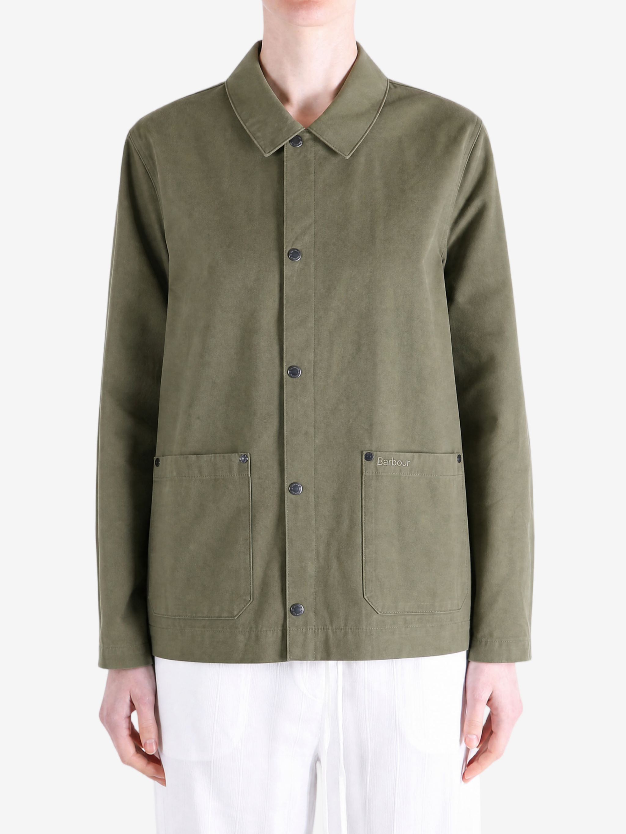 Green jacket worn by a person, showing the jacket fit