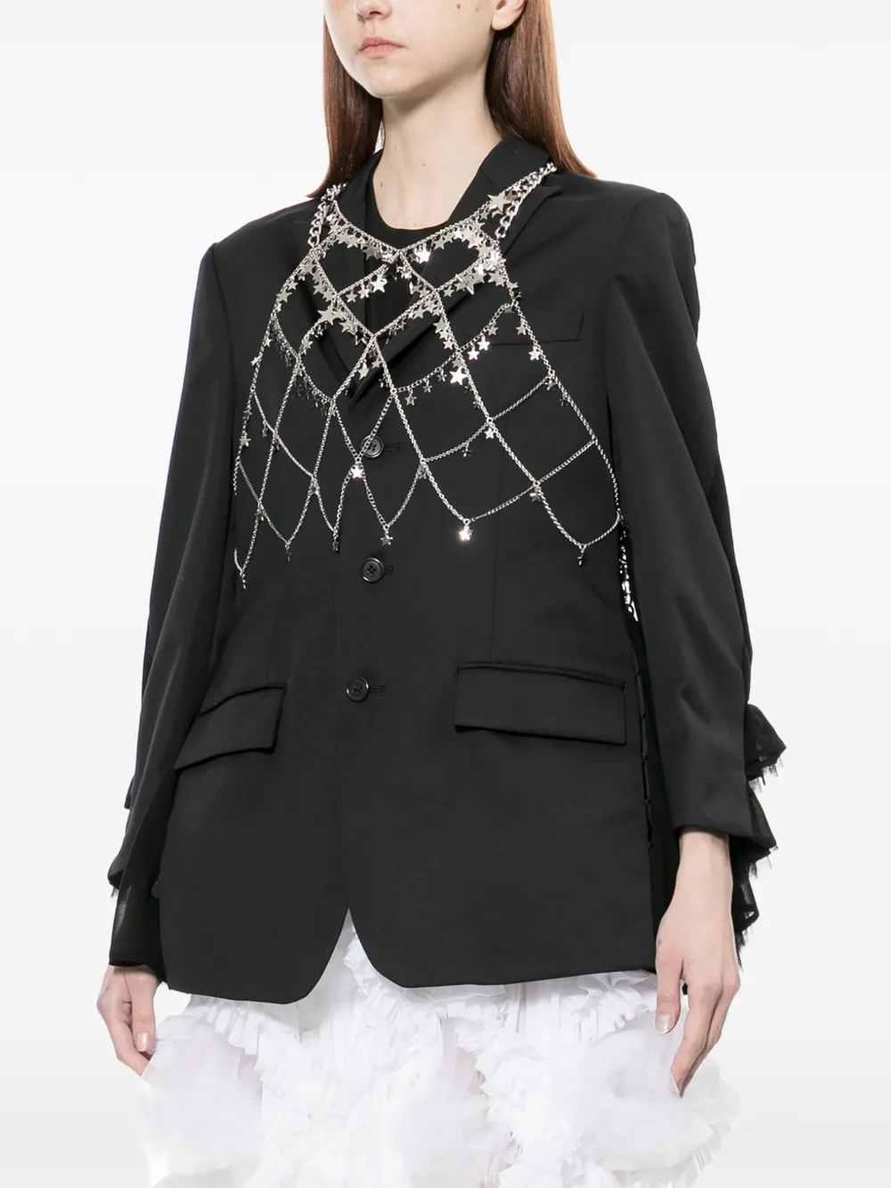 grey tops worn by a person, showing the tops  fit