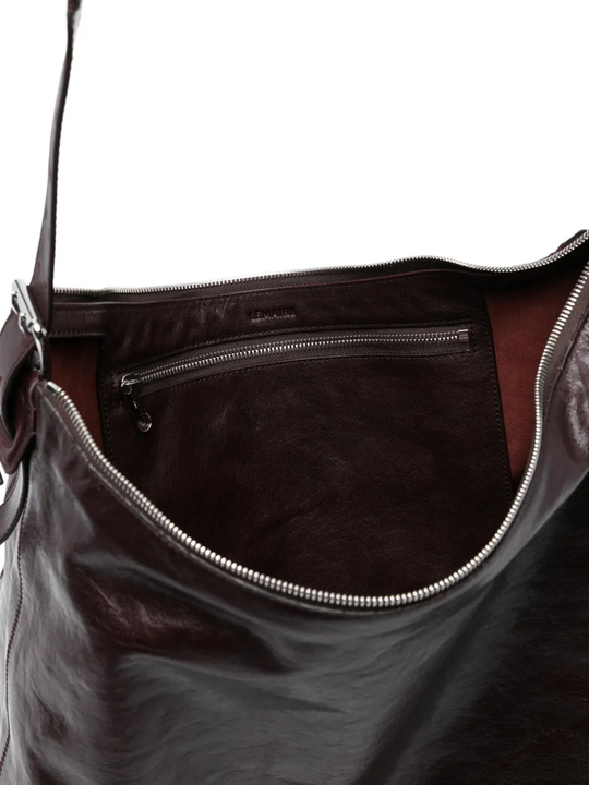 close up of brown bags, showing texture of the leather  fabric