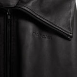 Close up of Black jacket, showing texture of the 100% calf leather made fabric