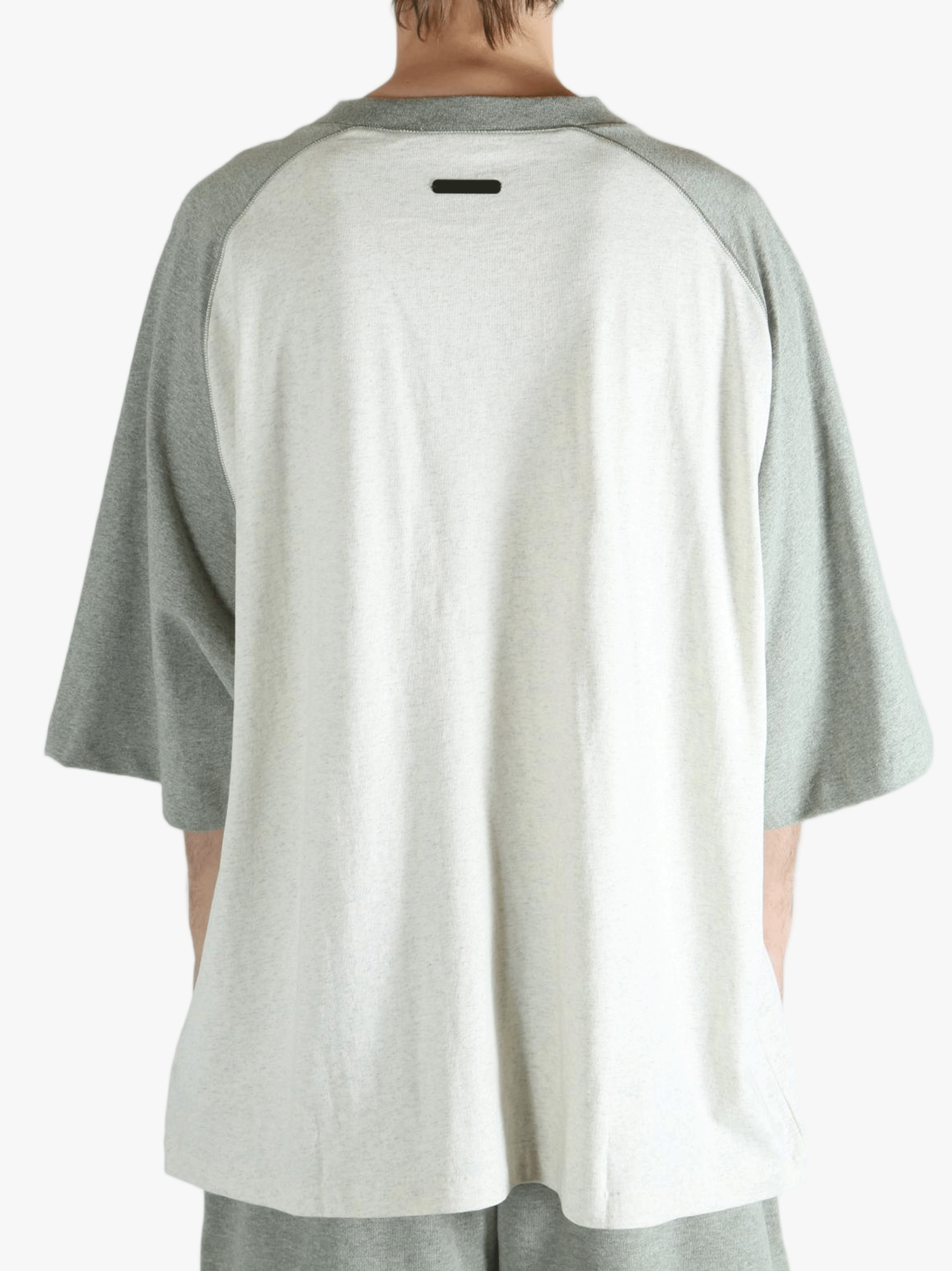 White t-shirt worn by a person, showing the shirt's fit