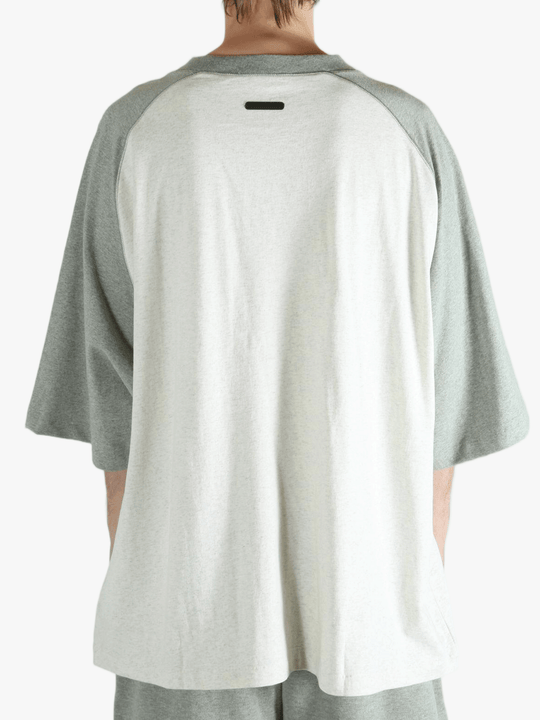 White t-shirt worn by a person, showing the shirt's fit