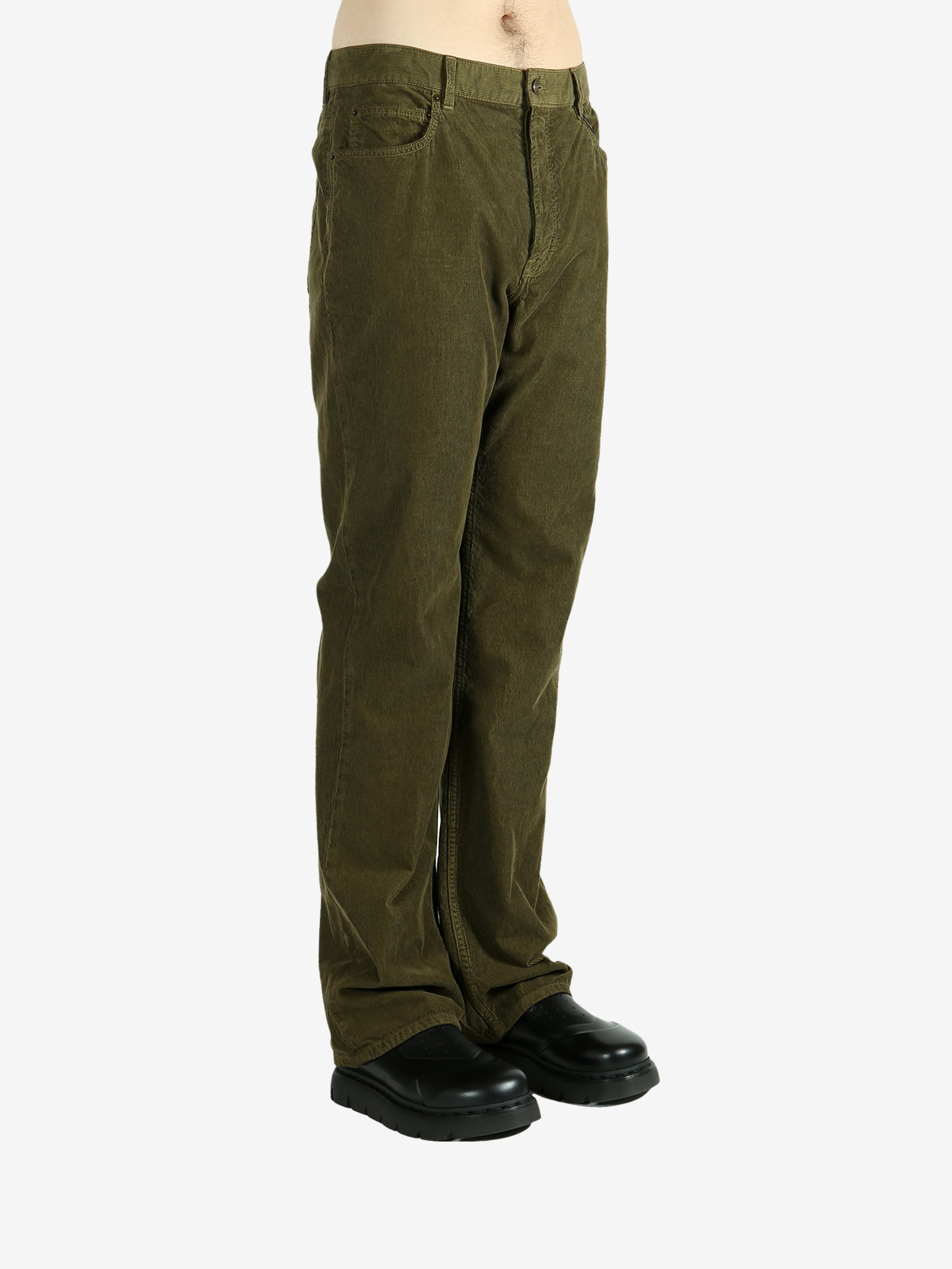 Green pants worn by a person, showing the pants's fit