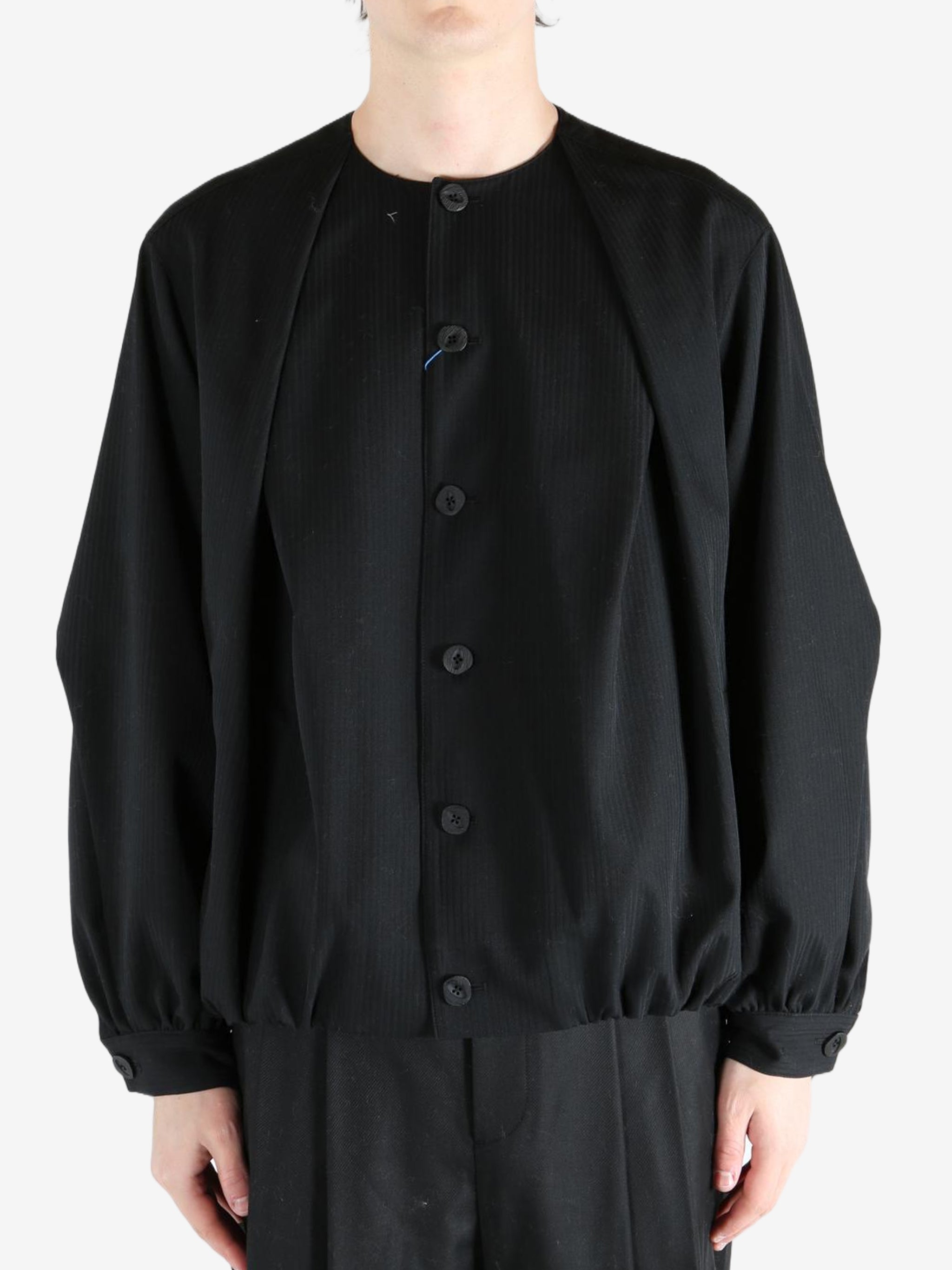 Black coats worn by a person, showing the coats fit