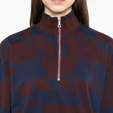 Burgundy sweater,worn by a person, showing the sweater's fit