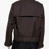 Brown jacket worn by a person, showing the jacket's fit