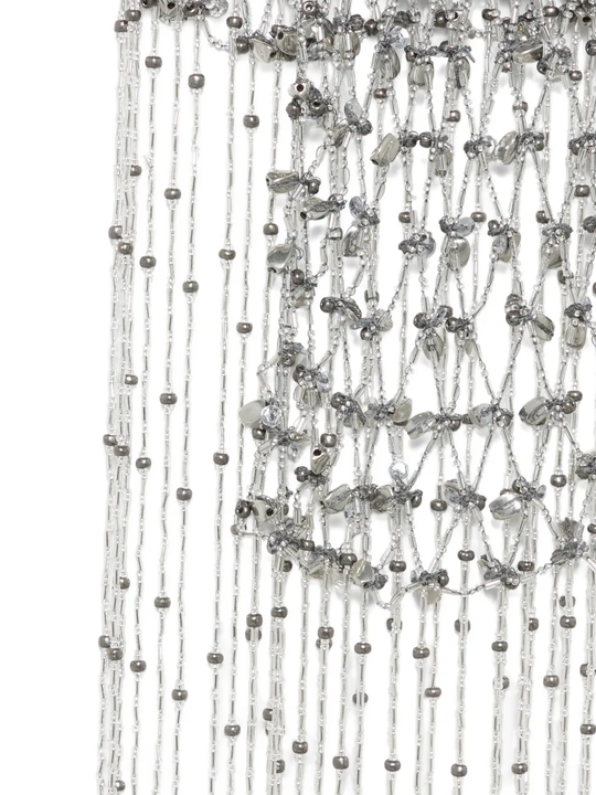 Close up of silver necklace, showing the detail of silver material