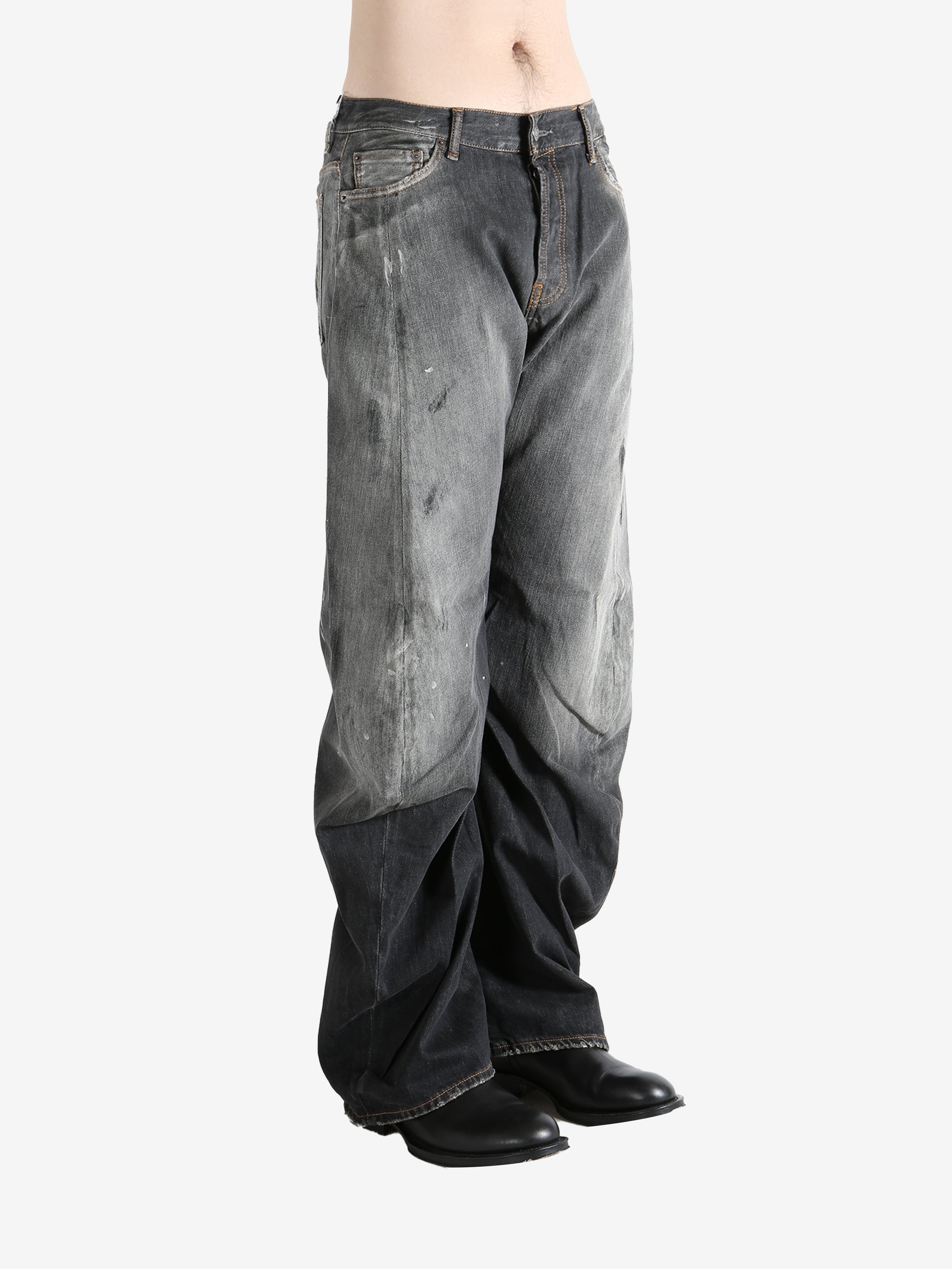 Black jeans worn by a person, showing the jeans fit