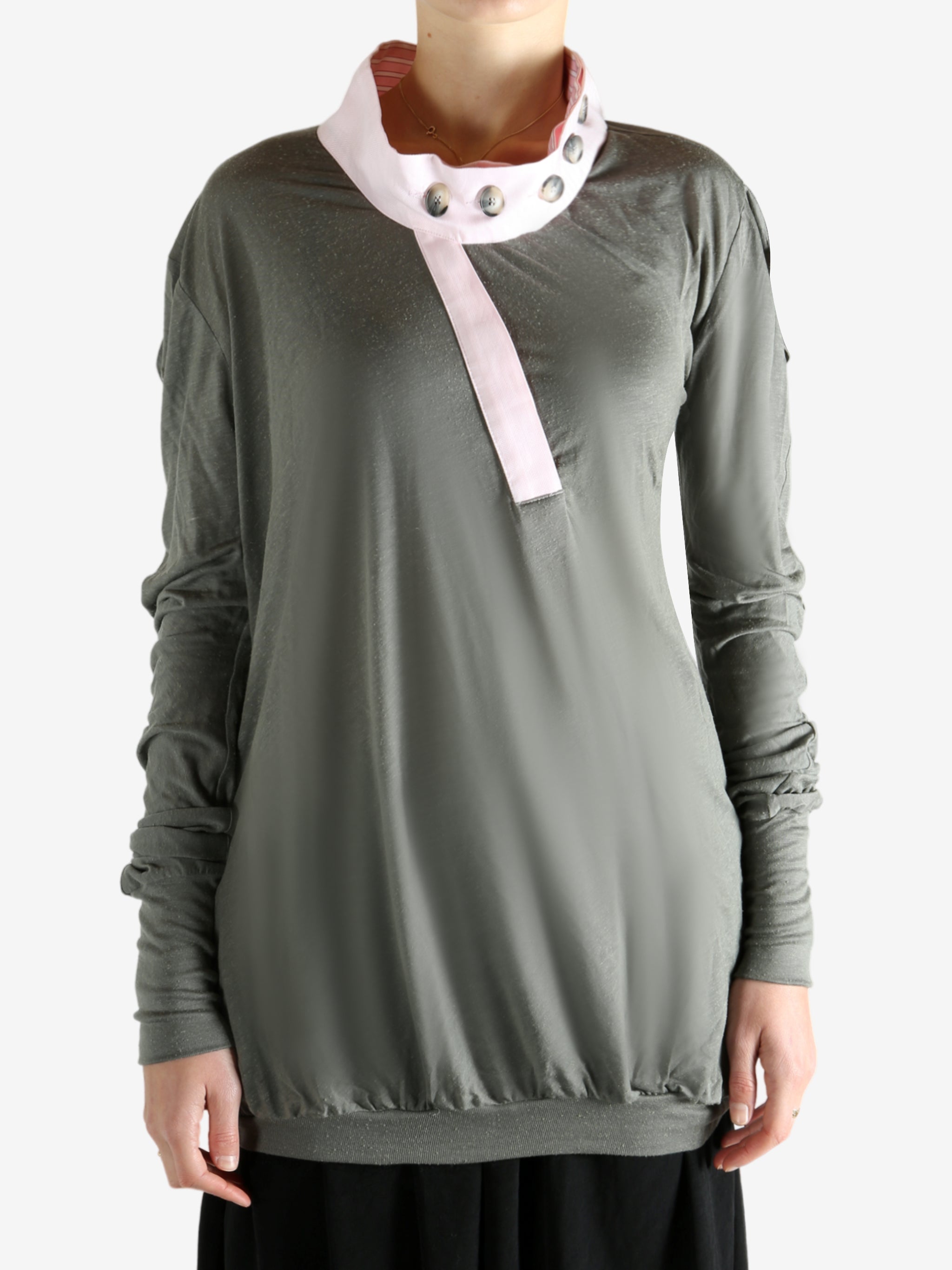 Grey tops worn by a person, showing the tops fit