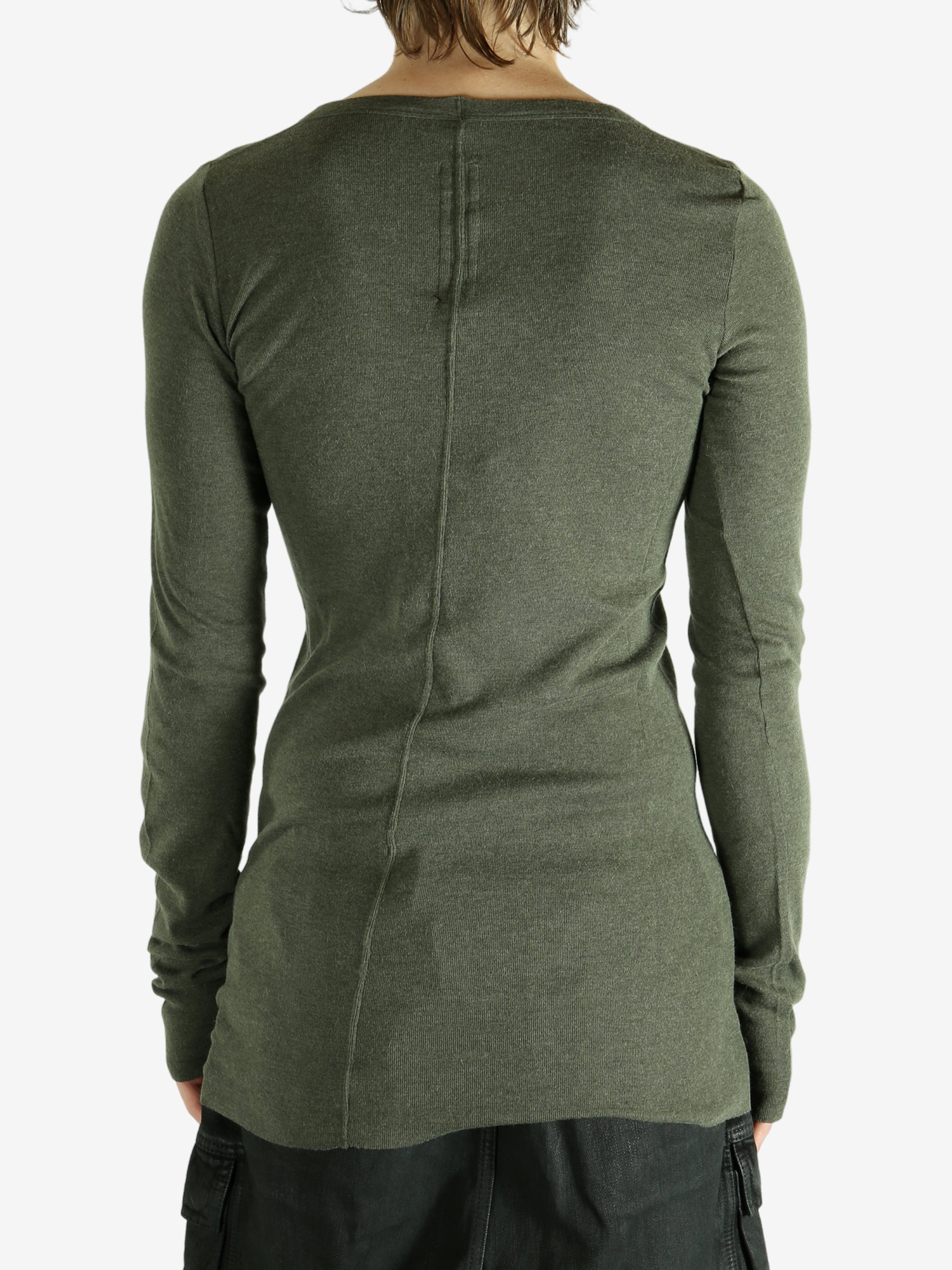 Green t-shirt worn by a person, showing the shirt's fit