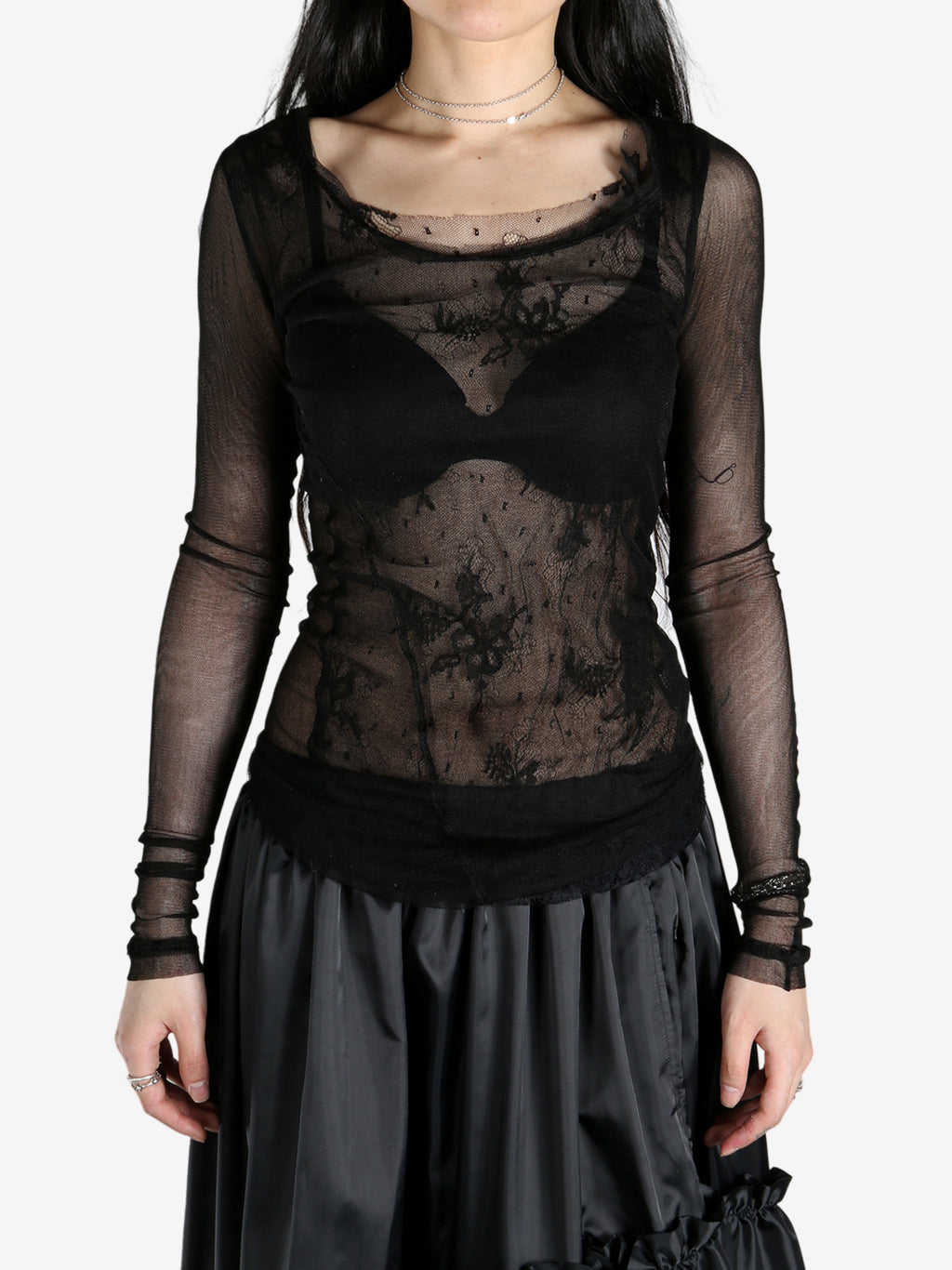 Black t-shirts worn by a person, showing the t-shirts fit