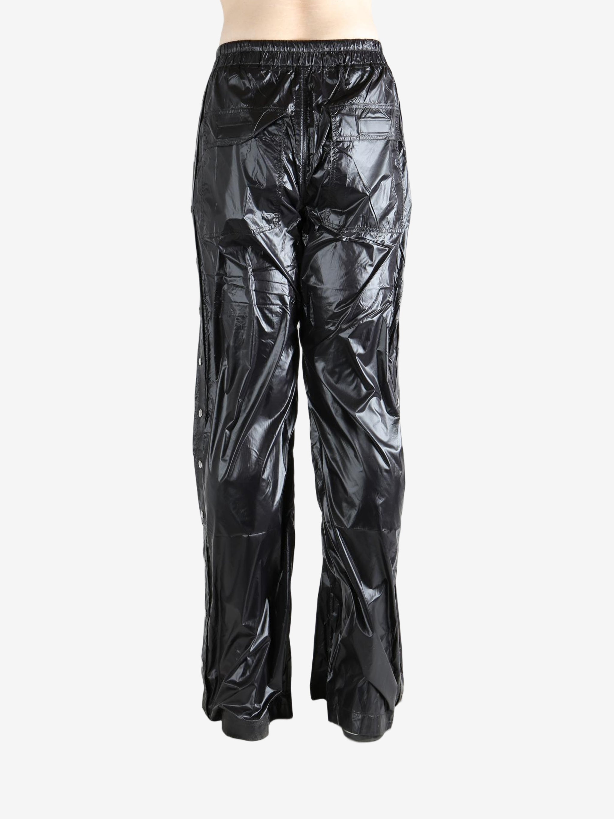 Black pants worn by a person, showing the pants' fit