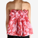 Red top worn by a person, showing the top fit