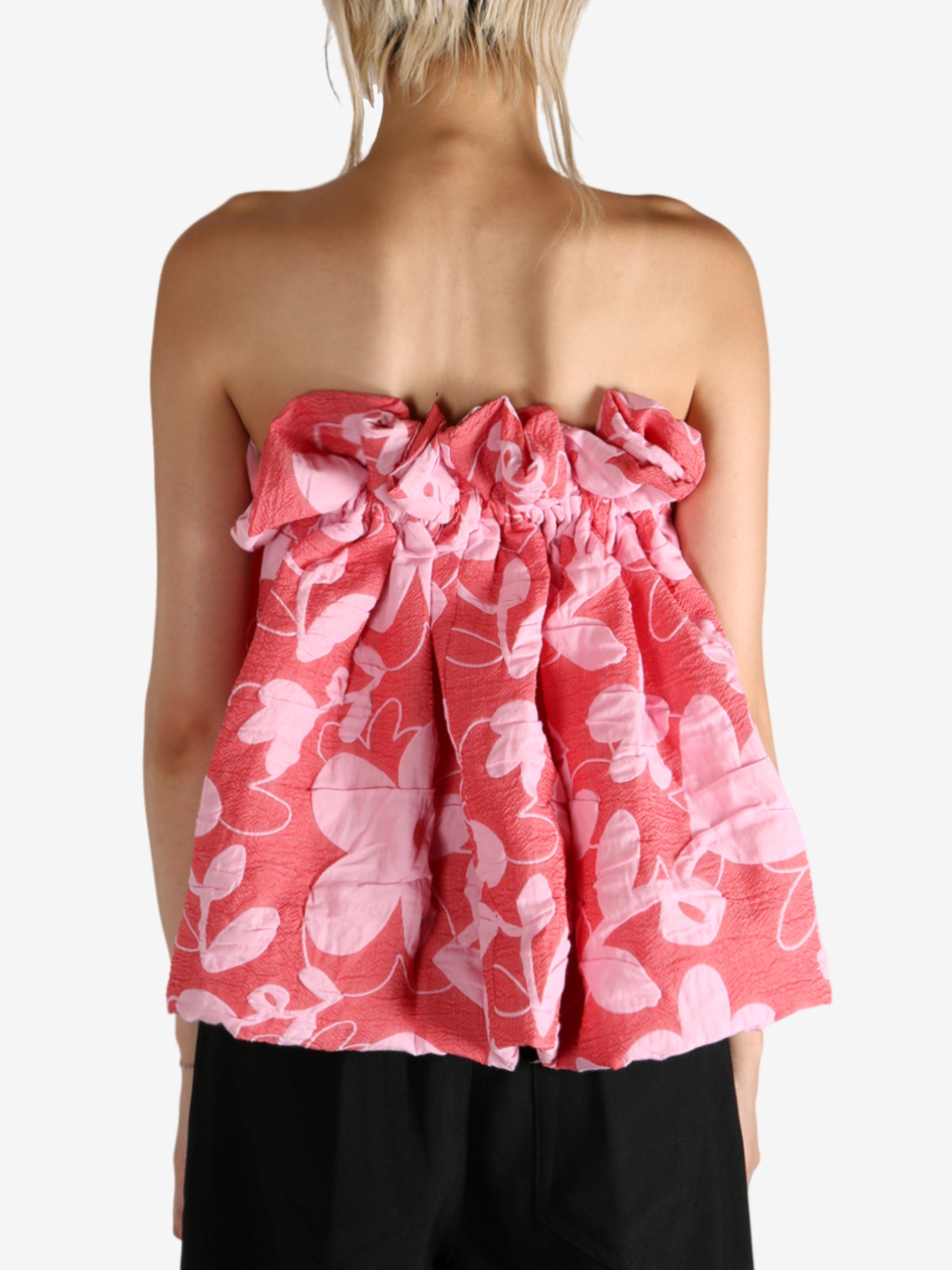 Red top worn by a person, showing the top fit