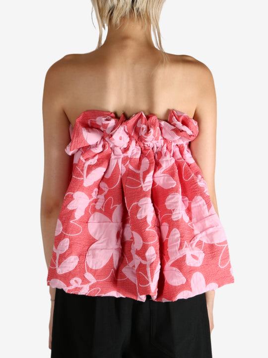 Red top worn by a person, showing the top fit