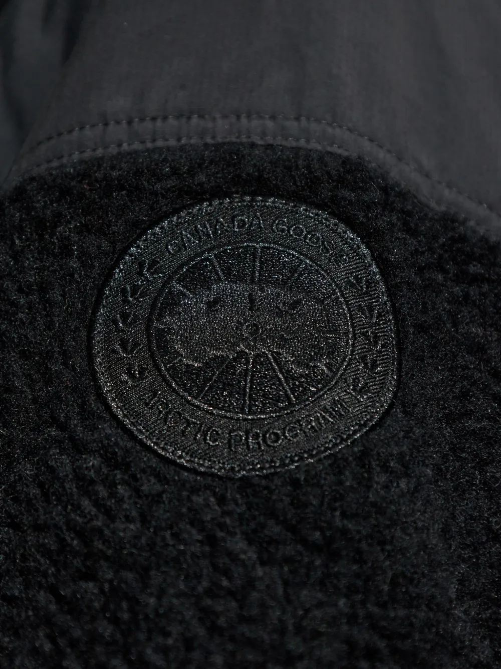 Close up of black jacket,showing texture of the wool fabric.