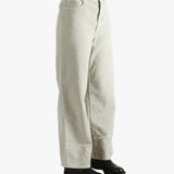 White pants worn by a person, showing the pants' fit