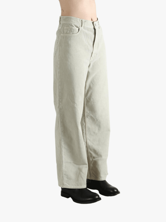 White pants worn by a person, showing the pants' fit