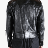 Black leather jacket worn by a person, showing the jacket fit