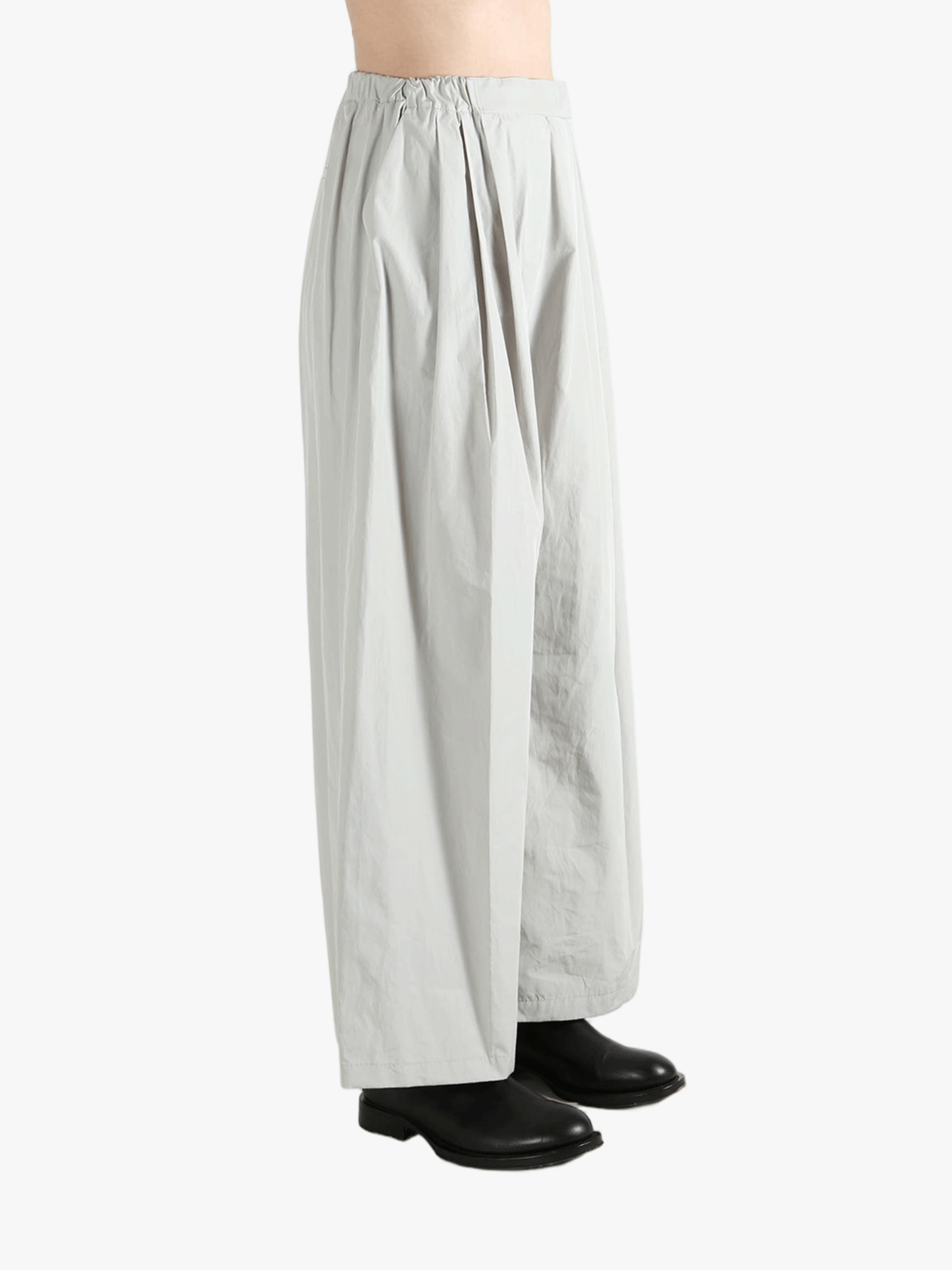 Grey pants worn by a person, showing the pants' fit