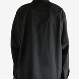 Black shirt worn by a person, showing the shirt's fit