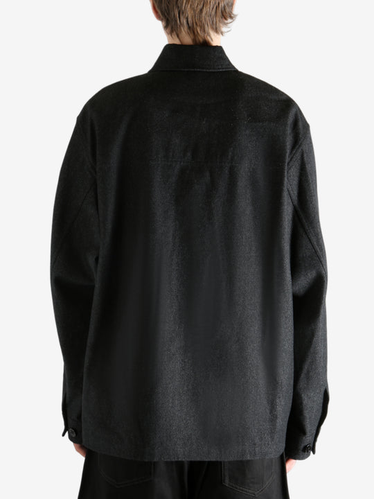 Black shirt worn by a person, showing the shirt's fit