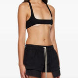 Black top worn by a person, showing the top fit